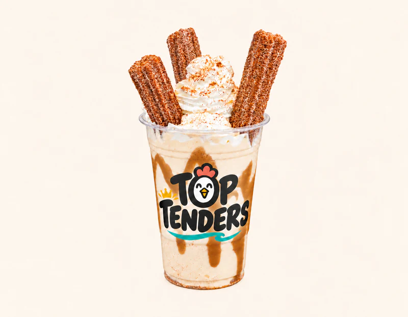 Biscoff Vanilla Churro Shake topped with whipped cream and churros in a Top Tenders cup